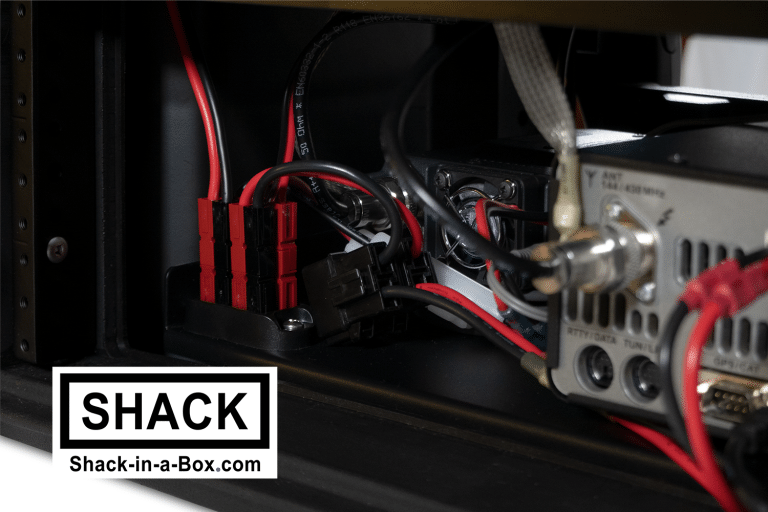 Close-up of the red Powerpole power cables and coax inside the Yaesu All-in-One Go Box