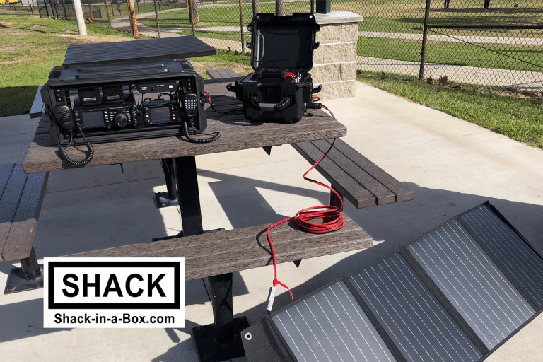 Yaesu All-in-One Go Box on a picnic table with a solar panel in the foreground