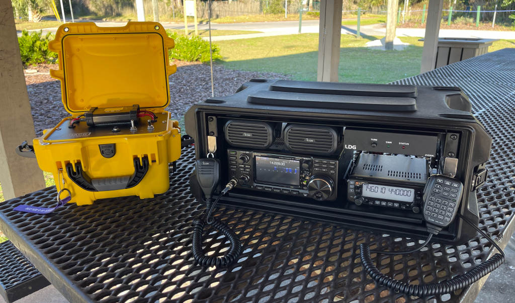 HF/VHF/UHF All-in-One Go Box with Icom IC-7300 and IC-2730A on a picnic table