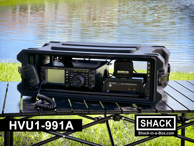 HVU1-991A HF/VHF/UHF Go Box on a folding table by the water