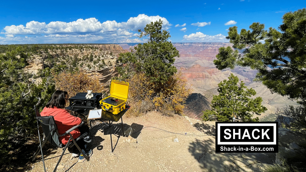 Operator at a Grand Canyon overlook with a Shack-in-a-Box Go Box set up on a folding table